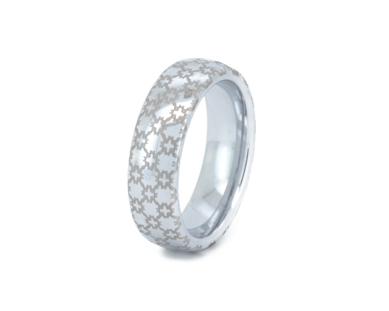 Silver ring with a textured pattern on a white background
