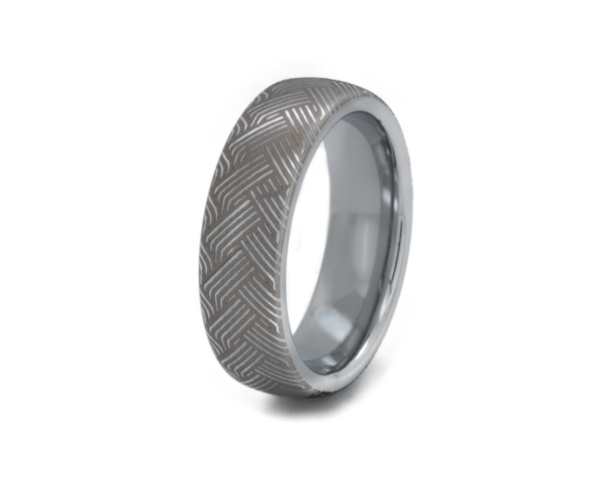Silver ring with a textured pattern on a white background