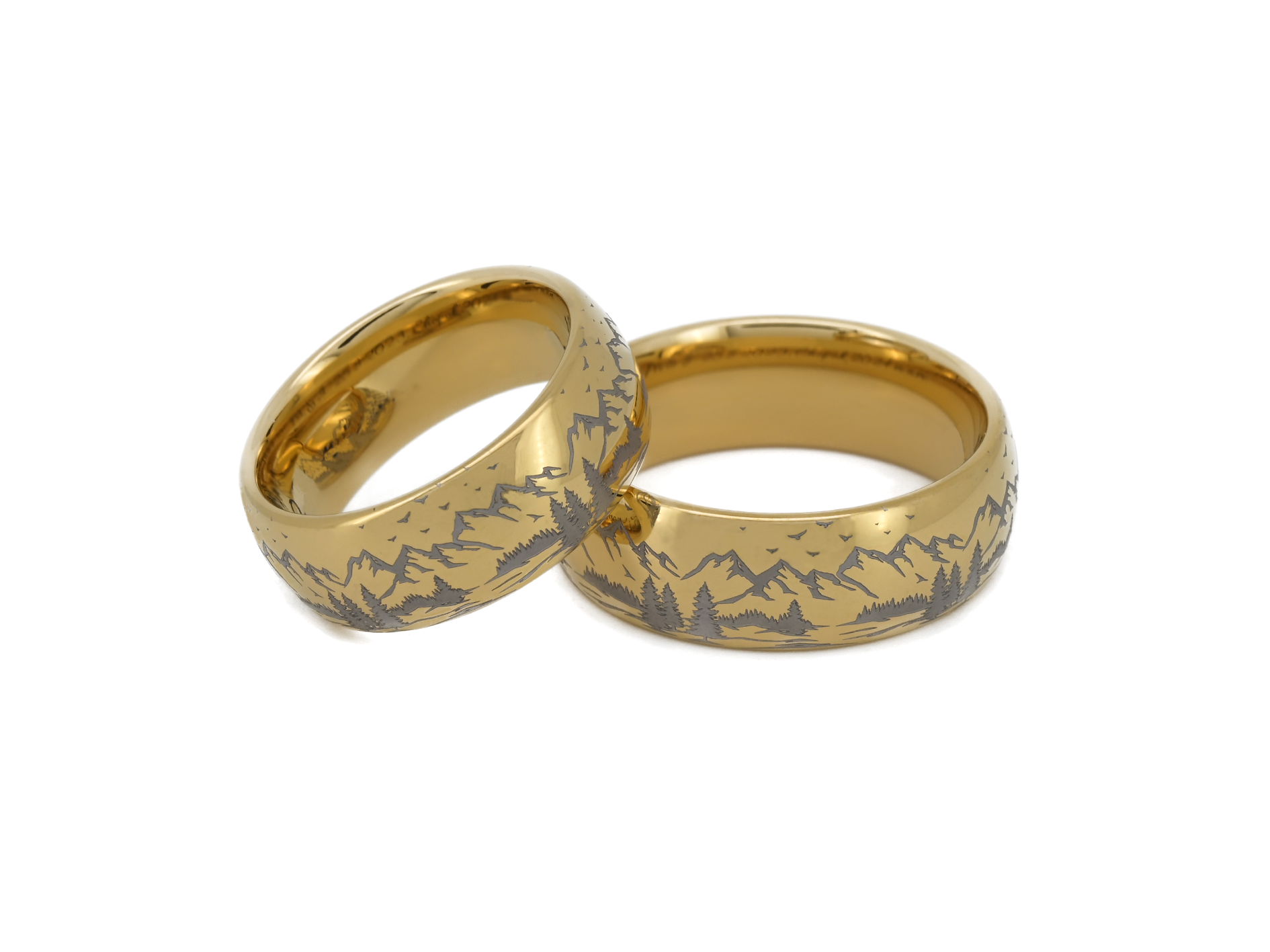 Two matching gold tungsten rings with engraved mountain landscape, symbolizing connection and shared journey