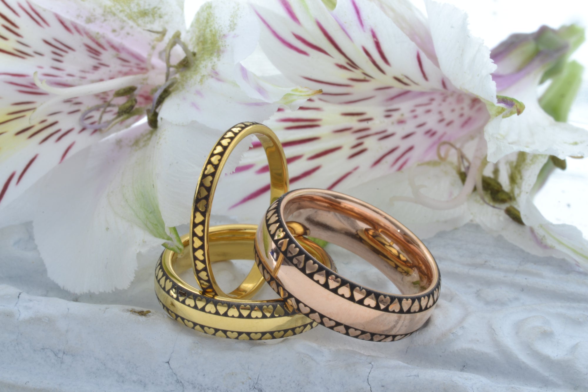 Hands of a newlywed couple wearing holographic HoloRing rings