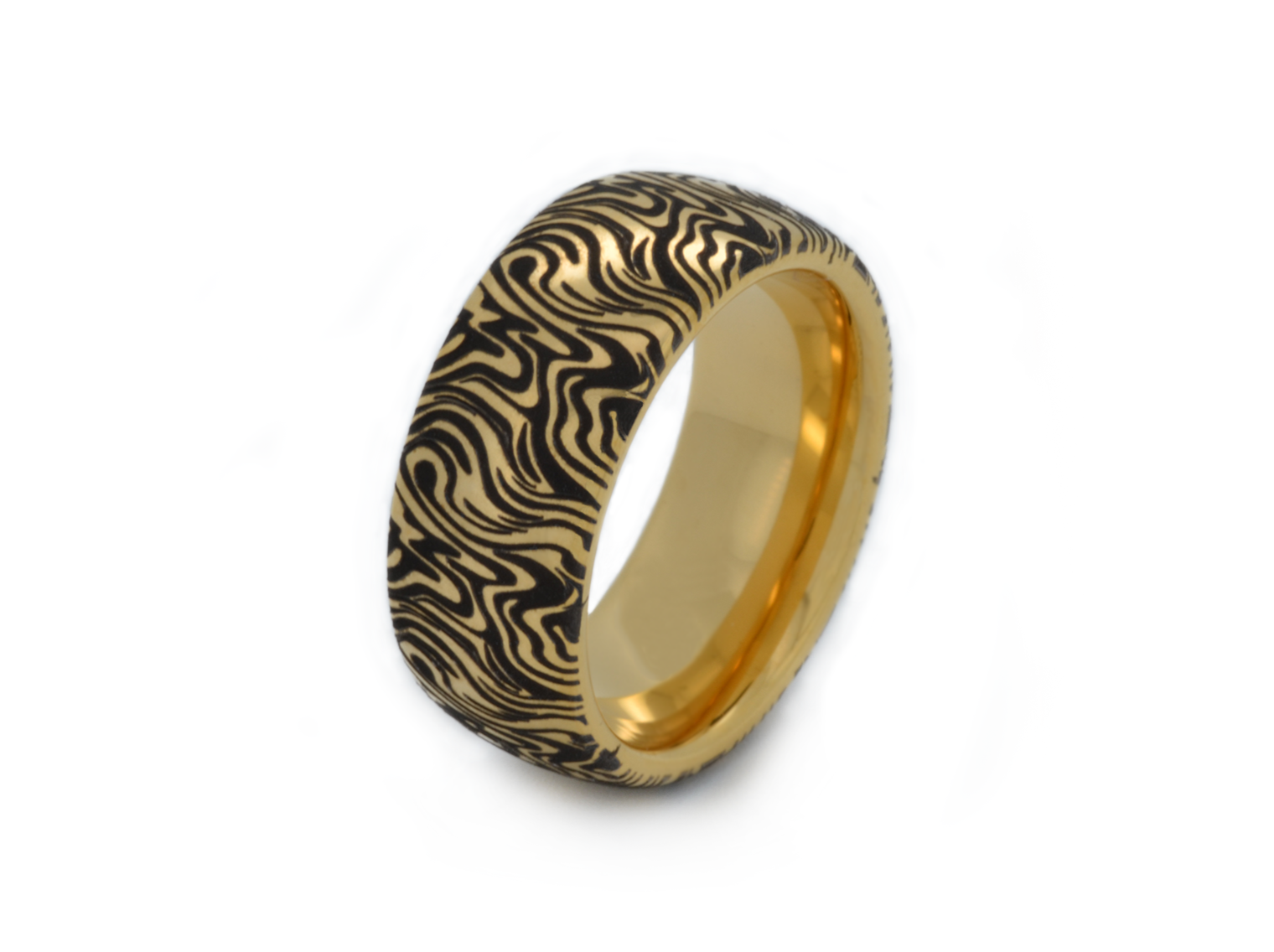 Gold wedding band featuring an intricate black wave pattern, creating a dynamic and artistic design, isolated on a white background.