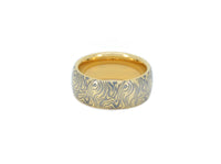 Product photo of the Golden Mokume Majesty tungsten ring with laser-engraved surface detail.