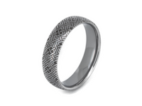 Eternal Knot tungsten ring with laser-engraved surface detail, shown against a light background.