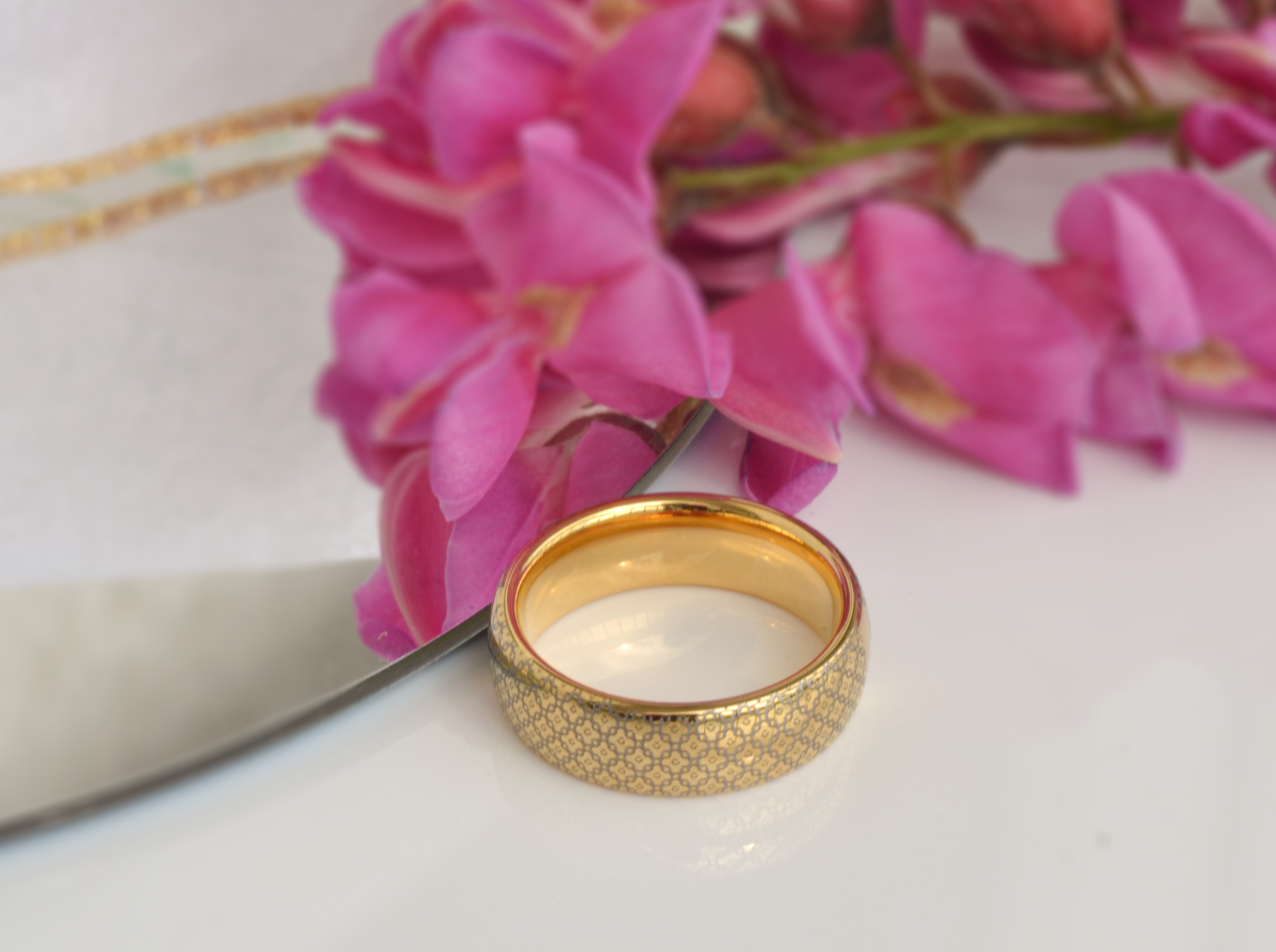 Gold tungsten ring with a timeless diamond pattern and a shiny finish, featuring an elegant design.