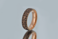 Product photo of the Petal Dance tungsten ring with laser-engraved surface detail.