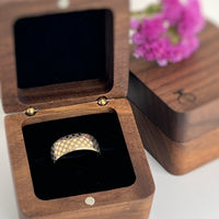 Product photo of the Astral Glow tungsten ring with laser-engraved surface detail.