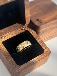 Product photo of the Celestial Grid tungsten ring with laser-engraved surface detail.