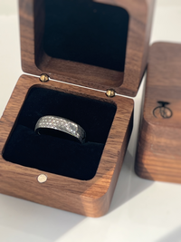 Product photo of the Prism Eternity tungsten ring with laser-engraved surface detail.
