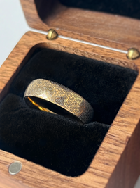 Product photo of the Hexa Maze tungsten ring with laser-engraved surface detail.
