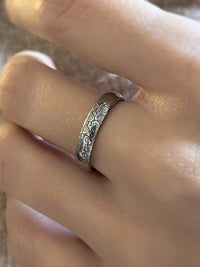 Close-up of Silver Blooming Rose tungsten ring worn on a finger, showcasing the detailed rose engravings.