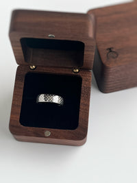 Product photo of the White Gold Quilted Elegance tungsten ring with laser-engraved surface detail.