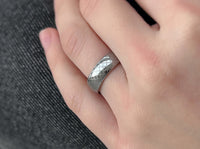 White Gold Quilted Elegance tungsten ring with laser-engraved surface detail, worn on a hand.