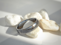 Product photo of the Eternal Knot tungsten ring with laser-engraved surface detail.