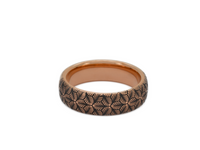 Product photo of the Petal Dance tungsten ring with laser-engraved surface detail.