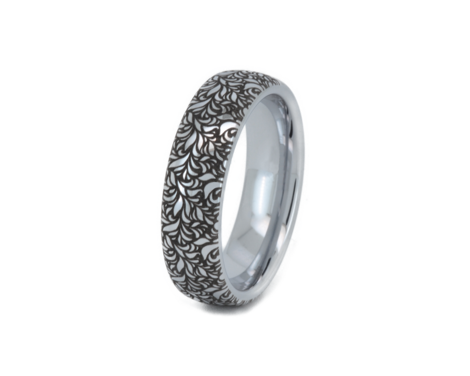 Silver tungsten carbide ring with detailed black botanical engraving on a polished band. Unique nature inspired wedding ring with elegant leaf pattern.