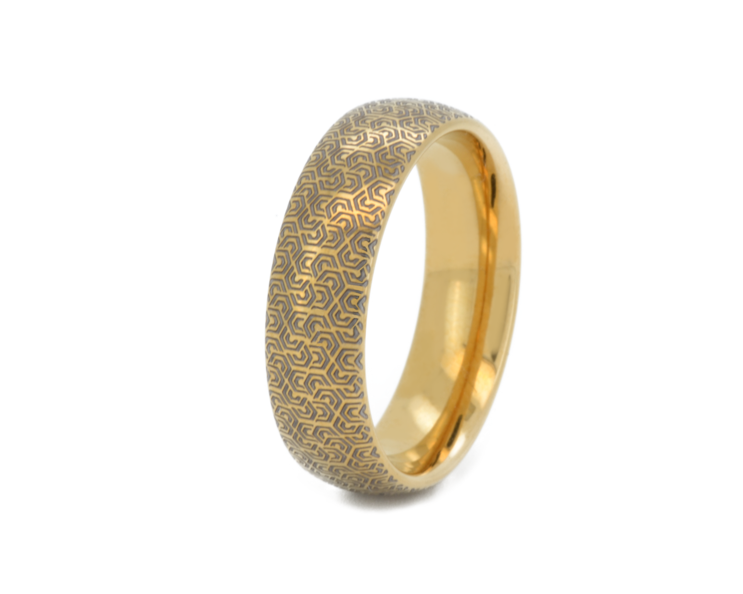 Gold ring with intricate design on a white background