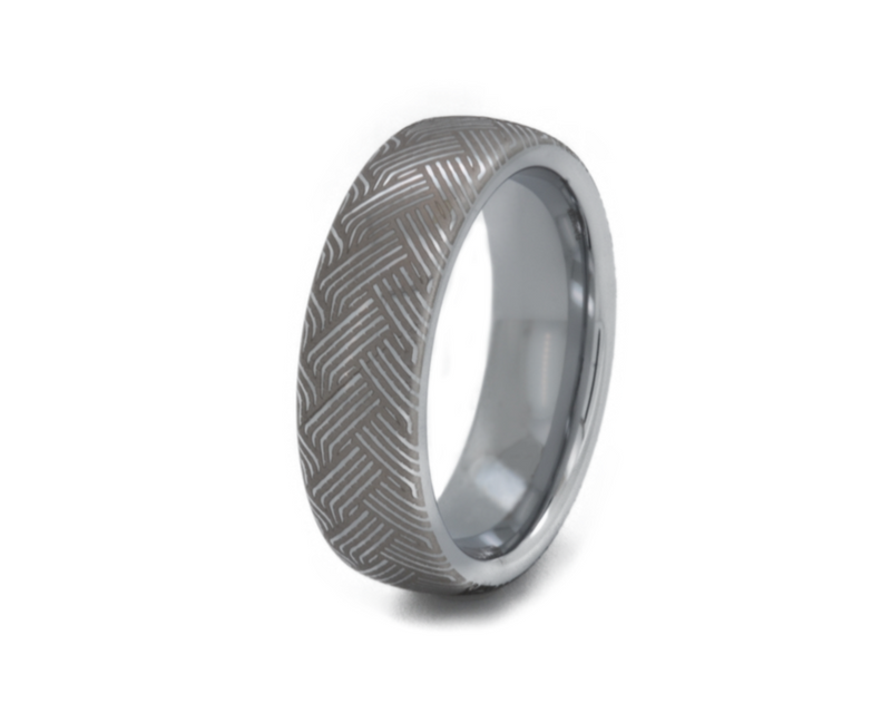 Silver ring with a textured pattern on a white background
