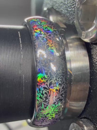 Close-up video of the Baroque Radiance tungsten ring showing holographic baroque scrollwork shifting through rainbow colors.