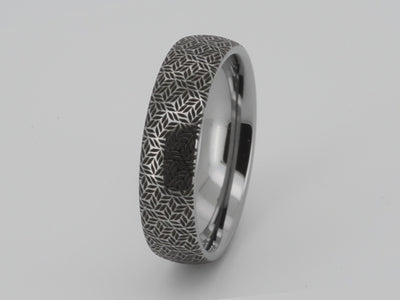 video of white gold tungsten ring with engraved design similar to frozen leave pattern. Black geometric engraving.