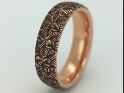 Rose gold tungsten ring with an intricate, black-engraved petal-like pattern, on a white background offering a delicate and refined look, perfect for weddings, special occasions, or everyday wear.